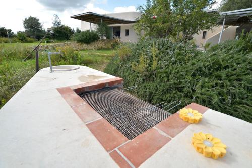 a grill on top of a patio in a yard at Villa Vendicari in Casa Maccari