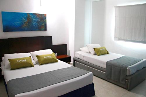 En eller flere senge i et værelse på Ayenda 1801 El Oceano