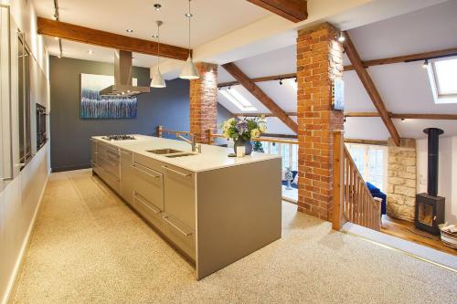a kitchen with a sink and a brick wall at Host & Stay - The Old Pottery in Pickering