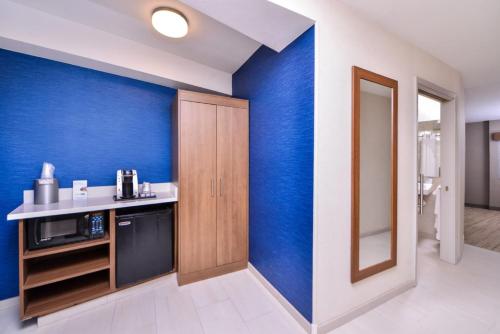 a kitchen with blue walls and a counter with a sink at Holiday Inn Express Walnut Creek, an IHG Hotel in Walnut Creek