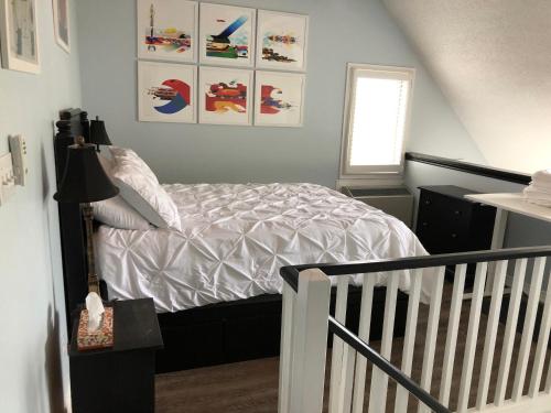 a bedroom with a bed with a crib in it at Artistic Hillside Loft in Blue Mountains