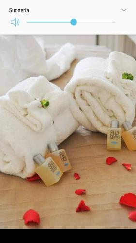 a picture of a white blanket on a table with hearts at Stunis Buze Suite in Ostuni