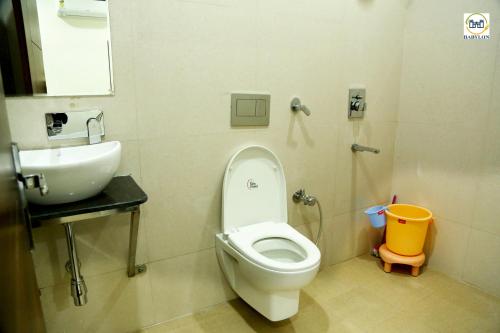 a bathroom with a toilet and a sink at HOTEL BABYLON REGENCY, Opp Krishna Janmabhoomi Temple in Mathura