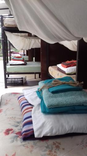 a room with several bunk beds and pillows on the floor at Bolita Trails and Lodging in Dos Brazos