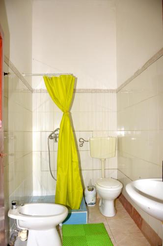 a bathroom with a toilet and a sink at Ana Chaves Residence in São Tomé