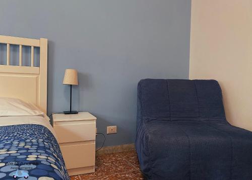 a bedroom with a bed and a chair at Ale&Andrea Apartments in Rome