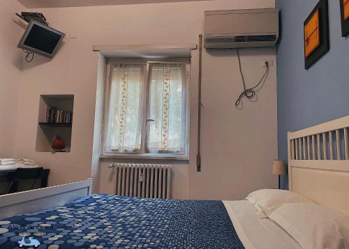 a bedroom with a bed and a window at Ale&Andrea Apartments in Rome