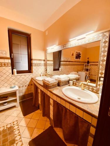 a bathroom with two sinks and a large mirror at VILLA "Casa al Chiazzullo" in Mirabella Eclano