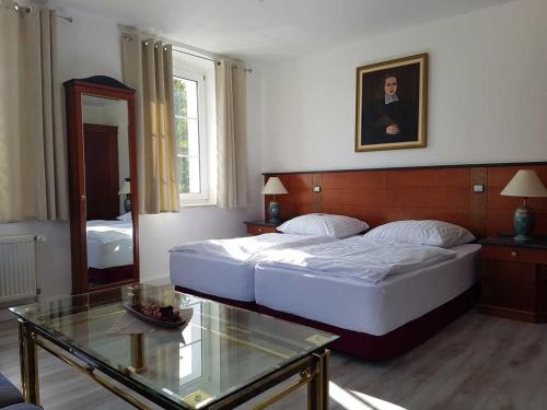 a hotel room with two beds and a mirror at Gasthof zur Alten Post in Wimmelburg