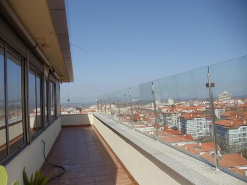 a balcony of a building with a view of a city at A MINHA ALEGRE CASINHA in Aveiro