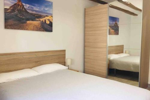 1 dormitorio con 2 camas y espejo en Buenavista Olite, en Olite