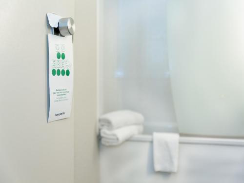 a bathroom door with a roll of toilet paper at Campanile Marne-La-Vallée - Torcy in Torcy