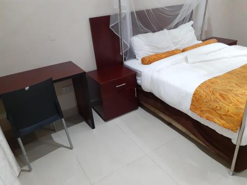 a bedroom with a bed and two night stands at Delight Lodge in Blantyre