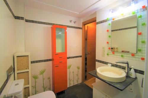 baño con lavabo y puerta roja en Modern CasaTuris Apartment with Castle Views A131, en Alicante
