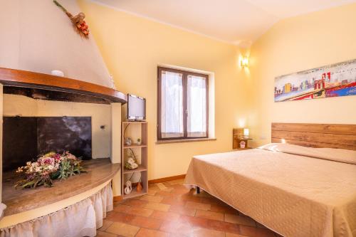 a bedroom with a bed and a fireplace at Terrazza Santa Chiara in Assisi