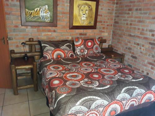 a bedroom with a bed with a patterned comforter at Eagle's Crest in Marloth Park