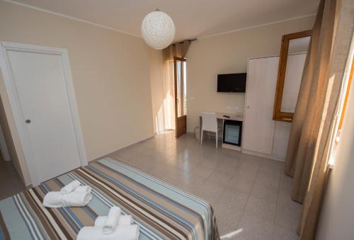a hotel room with a bed and a desk at Donna Rosa Accommodation in Tropea