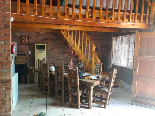 a dining room with a wooden table and chairs at Eagle's Crest in Marloth Park