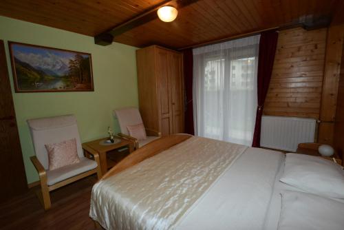 a bedroom with a white bed and a window at Apartment Dijak in Bohinj