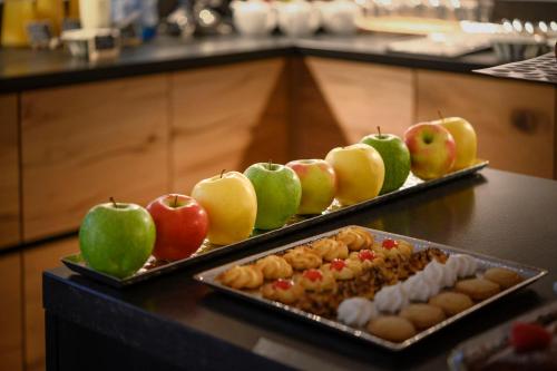 two trays of food on a table with apples at Castel Hörtenberg in Bolzano