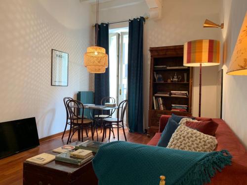 a living room with a couch and a table at Corso Garibaldi Suite in Milan