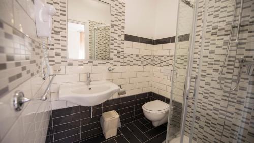 a bathroom with a sink and a toilet at Donna Rosa Accommodation in Tropea