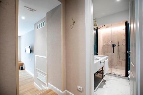 un baño con lavabo y ducha en Vicario Suites, en Roma