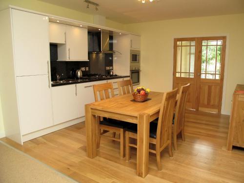 a kitchen and dining room with a wooden table and chairs at Croft Mill in Hebden Bridge