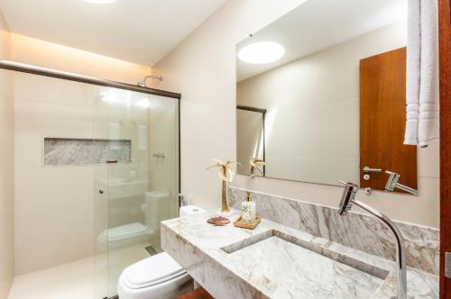 a bathroom with a sink and a toilet at Bahay Tatu in Pôrto de Pedras