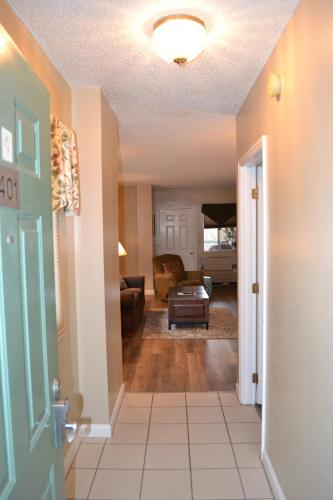 a hallway with a living room with a couch at River Place Condos #401 2BD in Pigeon Forge
