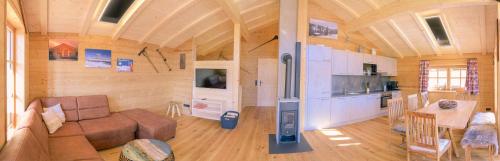 a living room and kitchen in a wooden house at Almhütte in Lachtal