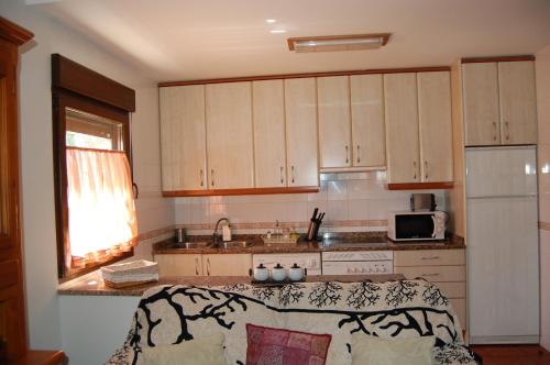 uma cozinha com armários de madeira e uma bancada em Casa Luna Lunera em Ayllón