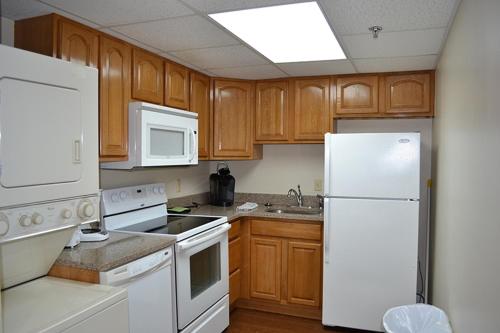 a kitchen with white appliances and wooden cabinets at River Place Condos #504 2BD in Pigeon Forge