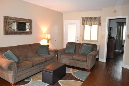 a living room with two couches and a table at River Place Condos #504 2BD in Pigeon Forge