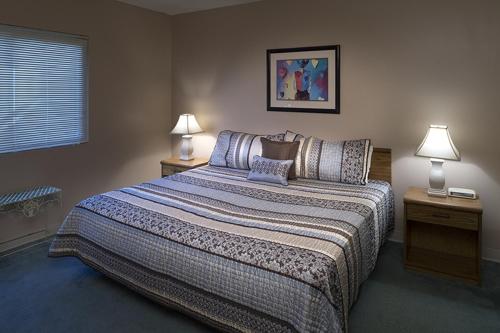 a bedroom with a large bed with two night stands at River Place Condos #602 2BD in Pigeon Forge