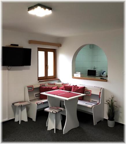 a room with a table and some chairs and a table at Hotel Alba in Deštné v Orlických horách