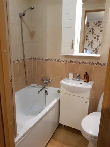 a bathroom with a tub and a sink and a toilet at Narva mnt 23 in Jõhvi