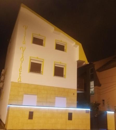 a large white building with windows on the side of it at Vila Violeta in Šabac