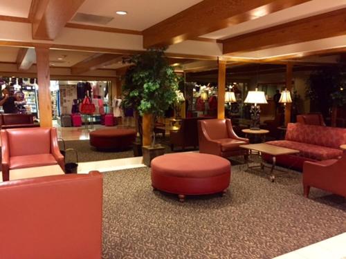 a lobby with couches and chairs and a store at GetAways at the Jockey Club in Las Vegas