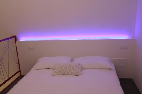 a room with a bed with a blue light on it at B&B COCO in Calvisano