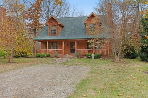 a brown house with a green roof at Kingfisher Cove Cabin 2 in Saugatuck