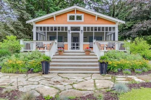 an orange house with stairs and a porch at Rise n Shine in Saugatuck
