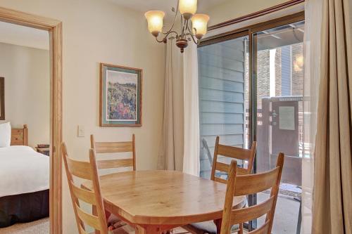 a dining room with a table and chairs and a window at One-Bedroom Apartment in Breckenridge
