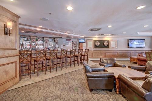 a bar in a hotel with leather chairs and tables at One-Bedroom Apartment in Breckenridge