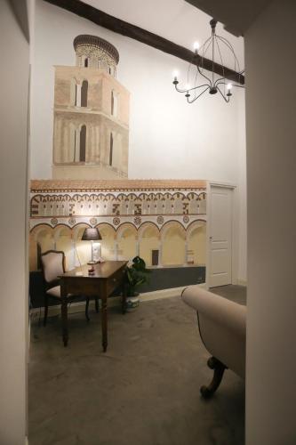 a room with a table and a clock tower on the wall at B&B Salerno al Duomo in Salerno
