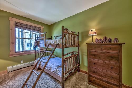 a bedroom with two bunk beds and a dresser at Three-Bedroom Townhouse in Kirkwood