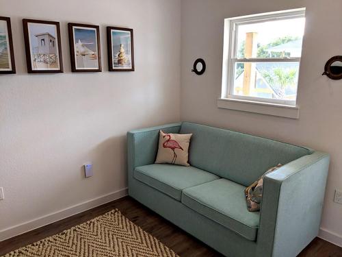 a living room with a blue couch and a window at Seaside RV resort in Seabrook