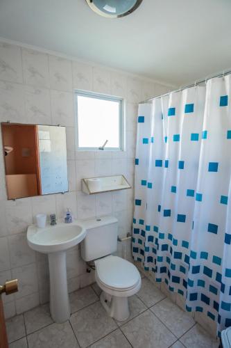 a bathroom with a toilet and a sink at Cabañas Maihue in La Serena