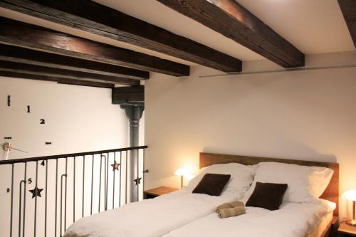 1 dormitorio con 1 cama grande con sábanas blancas en Sweet getaway loft - new, central & parking en Liubliana