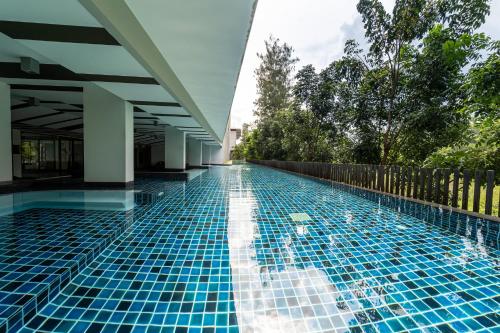 a swimming pool at a resort with blue tiles on it at ZcapeX2 in Bang Tao Beach